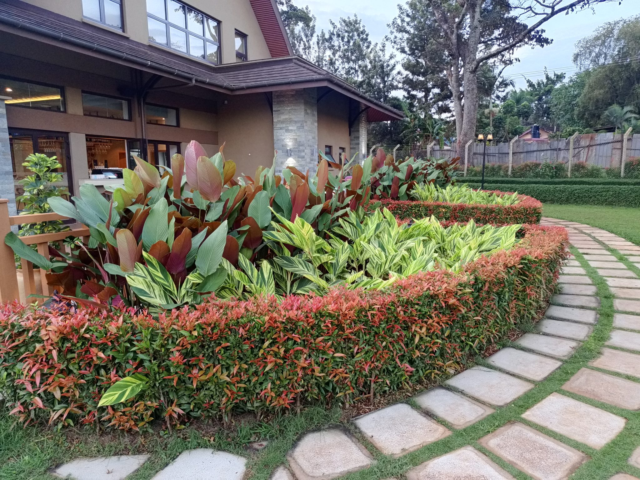 A planted garden bed along a stone walk